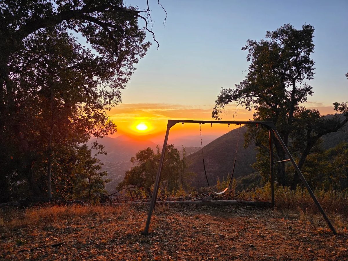 Swing overlooking the valley at sunset